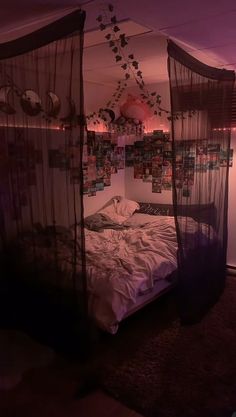 an image of a bed in the middle of a room with pictures hanging on the wall