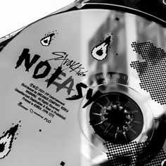 a black and white photo of a cd with the words notasy on it