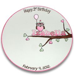 a happy 1st birthday plate with an owl on a tree branch and the name kabella