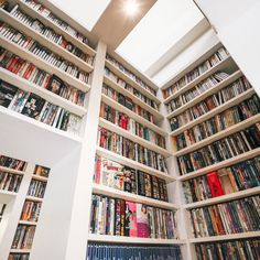 the bookshelves are filled with many different types of books and there is no one in them