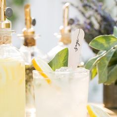 two glasses filled with lemonade and limeade next to each other on a table