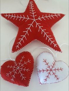 two red and white heart shaped ornaments on a table