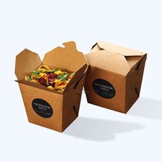 two brown boxes filled with different types of food