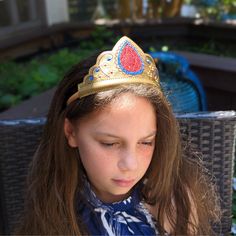 From Our Customers: “My granddaughter just loved her crown and wand...couldn't be happier with the quality and design.” “This is a great way for his imagination to grow! Excellent quality!” Short Description: Our Crowns and Wands are an excellent addition to costumes or in our opinion…wearing every day! ——————————————— Detailed Product Description: All of our crowns are made with marine vinyl and a felt backing and are attached to a coordinating satin covered headband. See specific color details Ruby Crown, Leather Crown, Princess Wands, Crown For Kids, Crown Gold, Hair Crown, Red Crown, Gold Vinyl, Gold And Red