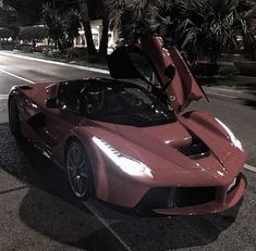 a red sports car is parked on the side of the road