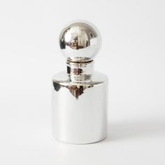 a metal container with a ball on top