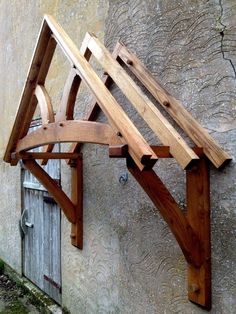 a wooden structure sitting on the side of a building