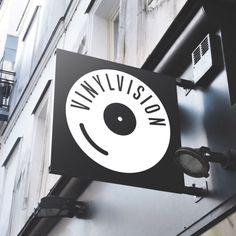 a black and white sign hanging from the side of a building