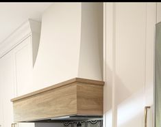 a stove top oven sitting inside of a kitchen next to a wall mounted range hood