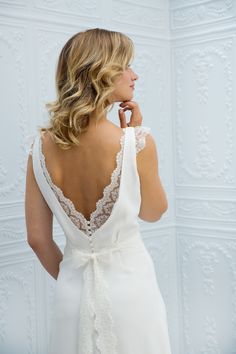 the back of a woman wearing a white wedding dress