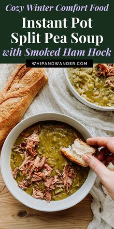 a person holding a piece of bread over a bowl of split pea soup with smoked ham hock