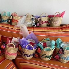 several baskets with personalized items are lined up on a couch