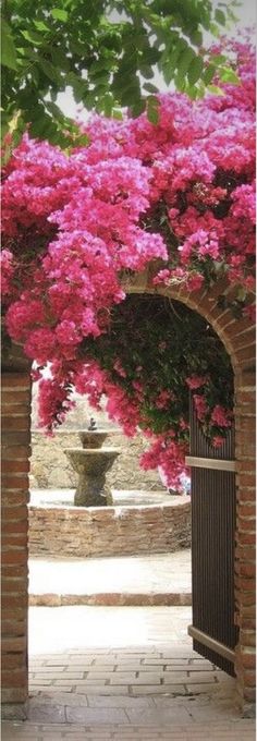 an archway with pink flowers on it