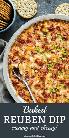 baked reuben dip creamy and cheesy in a casserole dish with crackers on the side