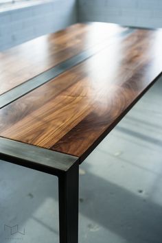 a wooden table with metal legs in a room