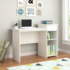 a white desk with a laptop on top of it next to a rug and window