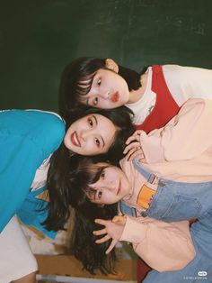 three young women are posing for the camera