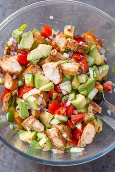 a glass bowl filled with meat and veggies