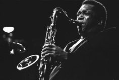 a black and white photo of a man playing a saxophone