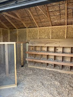 the inside of a barn with wooden shelves