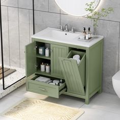 a bathroom with a sink and green cabinet