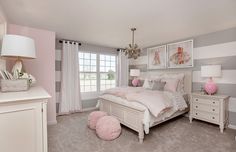 a bedroom decorated in pink and white with striped walls, carpeted flooring and furniture