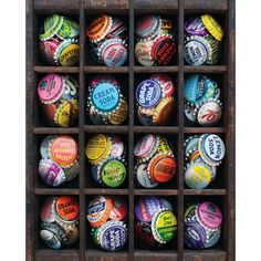 a wooden box filled with lots of different colored bottle caps