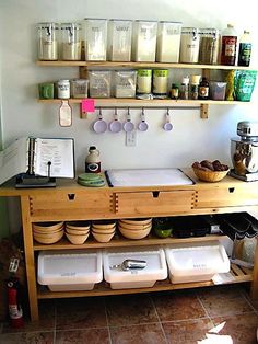 a kitchen with lots of dishes and utensils on the counter