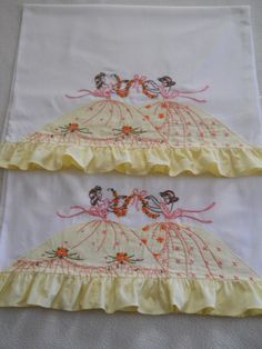 two white and yellow bedspreads with embroidered designs on them