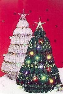 a small christmas tree sitting on top of a table next to a large white and red wall