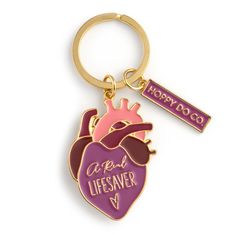 "FREE SHIPPPING OPTION in the USA.  The unique anatomical heart \"A Real Lifesaver\" keychain from HOPPY DO CO. is a great way to show off your passion. With its bright colors, unique anatomical design, and \"A Real Lifesaver\" message, this keychain makes a great cardiologist gift, nurse gift, or other medical professionals. Made from alloy and enamel, the heart charm measures approximately 2 inches by 1.1 inches and hangs on a split ring. Plus it includes a free gift box for easy gifting. GREAT GIFT FOR ANY OCCASION - Looking for a unique and memorable gift? This anatomical heart keychain makes a great gift, especially for a cardiologist, cardiac rehab nurse, or other medical professional. UNIQUE DESIGN - With a stylized anatomical design, bright colors, and \"A Real Lifesaver\" message, Rehab Nursing, Cardiologist Gift, Gold Keychain, Medical Student Gift, Medical Gifts, Doctor Gift, Professional Gifts, Anatomical Heart, Doctor Gifts