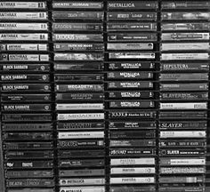 a large stack of dvd's stacked on top of each other in black and white