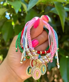 a woman holding several bracelets in her hand