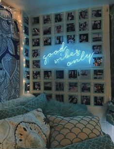 a bed with lots of pillows and pictures on the wall