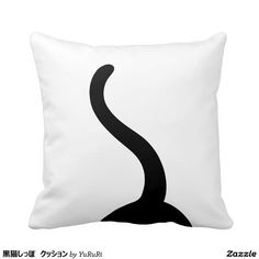 a black and white pillow with a curved design on the front, sitting against a white background