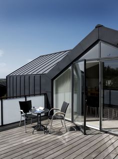 an outdoor deck with chairs and tables on it