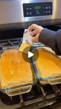 two pans of food sitting on top of an oven with one being put in the oven