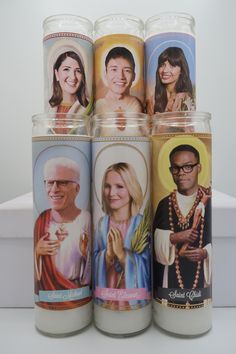 four candles with images of people on them