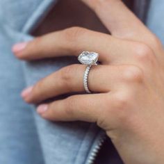 a woman's hand with a diamond ring on her finger