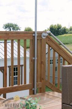 a wooden deck with an umbrella and wicker chair