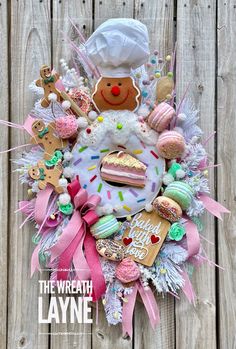 a wreath made out of cookies and doughnuts with a chef's hat on top