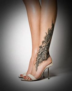 a woman's legs with tattoos and high heels