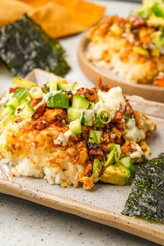 some food is sitting on a wooden plate