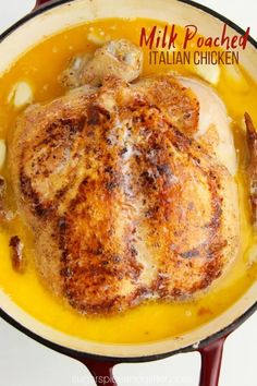 a chicken is cooked in a skillet on the stove with mustard and spices around it