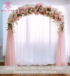 the wedding arch is decorated with pink and white flowers