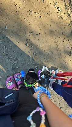 two people are holding onto their shoes on the ground