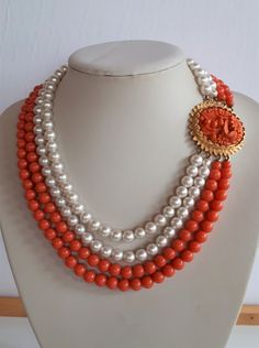 Gorgeous designer unsigned piece! Statement vintage haute couture pink salmon coral lucite plastic and faux pearl 4 rows necklace with huge molded coral lucite oval cameo clasp with gold plate frame and raised floral design. Shortest row without claps: 14 inches ; longest row: 18 inches ; beads: 8 mm; clasp: 1-3/4 x 1.5 x 0.5 inches. Good condition - the faux pearls may have minor imperfections - sold as is.  IMPORTANT TO READ: To make this a smooth and pleasant transaction experience for everyo Luxury Coral Beaded Necklace, Luxury Red Coral Round Beaded Necklace, Vintage Coral Beaded Necklaces, Vintage Haute Couture, Luxury Hand-strung Red Coral Beaded Necklaces, Flower Necklaces, Unique Hand-strung Red Coral Necklaces, Glass Gifts, Flower Necklace