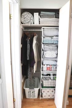 an organized closet with clothes, baskets and other items in it's doors open