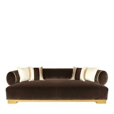 a brown and white couch with two pillows on top of the armrests, in front of a white background