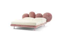 the bed is made up with pink and white fur on it's headboard